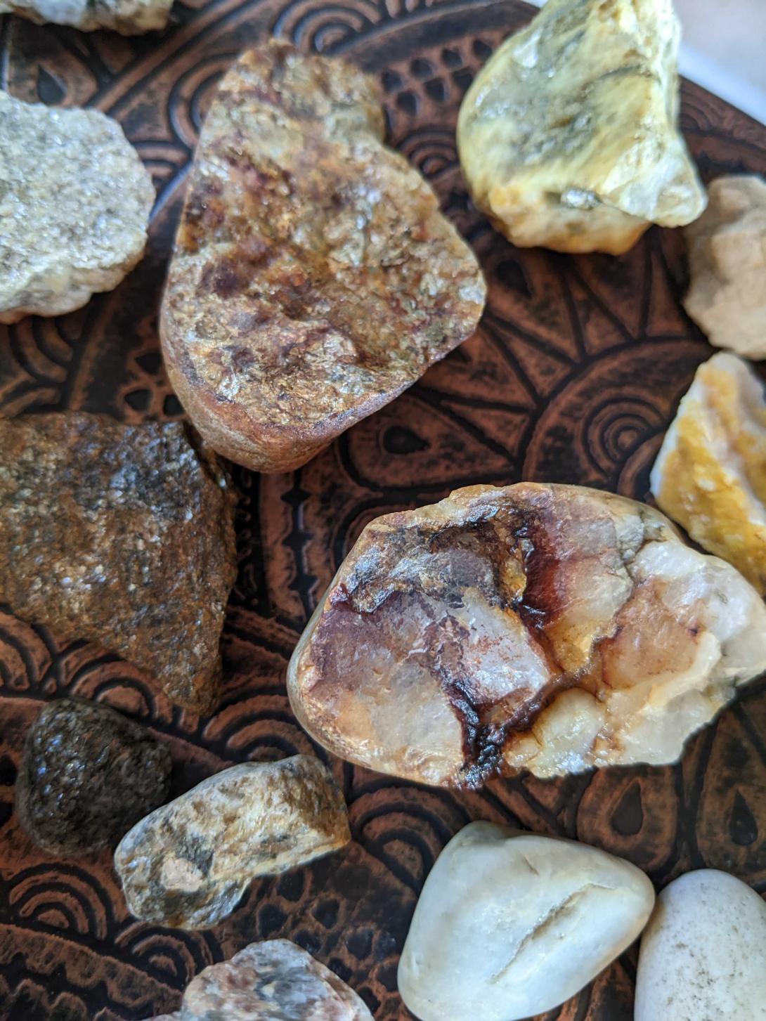 quartz river-tumbled rocks on a copper table